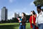Photograph of students walking across Victoria Park with the Charles Wilson and Attenborough tower in the background