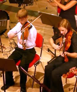 Photograph of two students playing violins