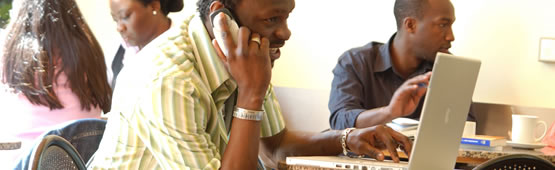 Student using a phone and laptop