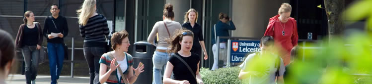 students walking and talking outside the library